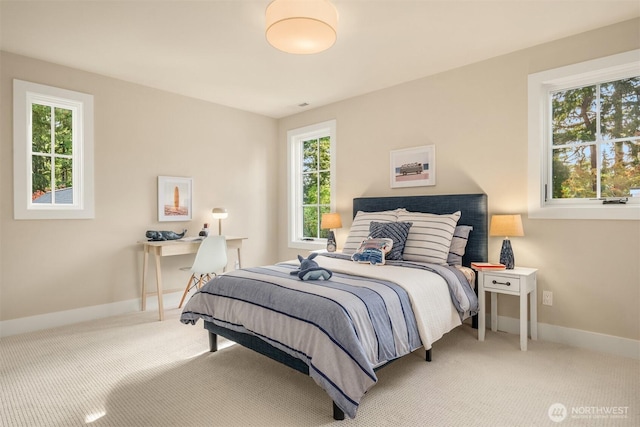 carpeted bedroom featuring baseboards