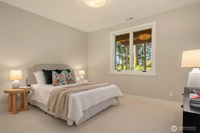 carpeted bedroom with baseboards and visible vents
