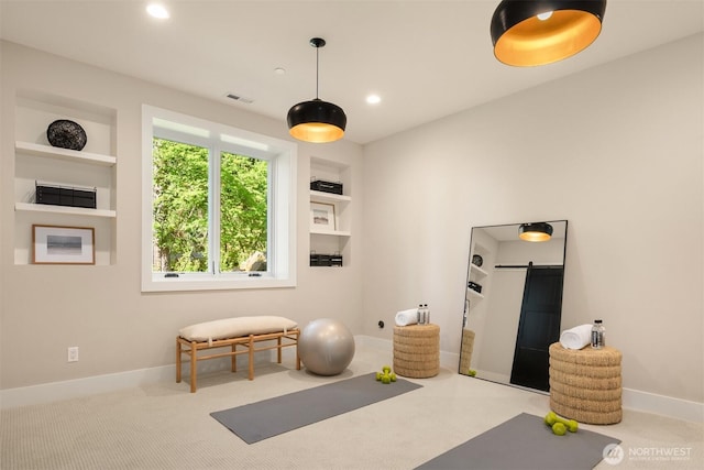 exercise area featuring baseboards, a barn door, built in shelves, and recessed lighting