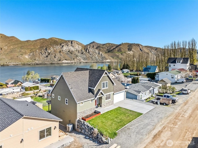 birds eye view of property featuring a water and mountain view