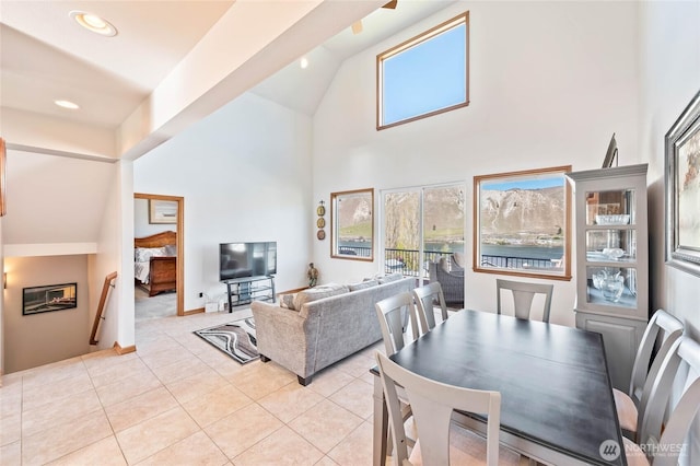 dining room featuring high vaulted ceiling, light tile patterned floors, and recessed lighting