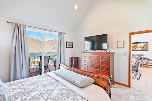 carpeted bedroom featuring baseboards, access to exterior, tile patterned flooring, and high vaulted ceiling