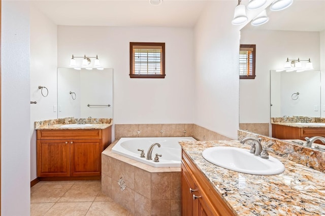 bathroom with tile patterned flooring, a bath, a sink, and two vanities