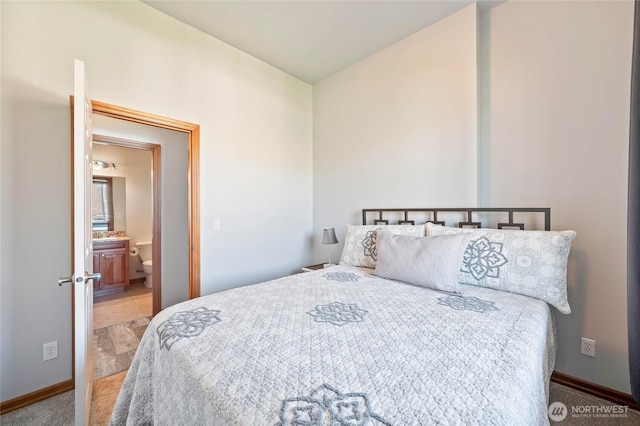 bedroom with baseboards and ensuite bathroom