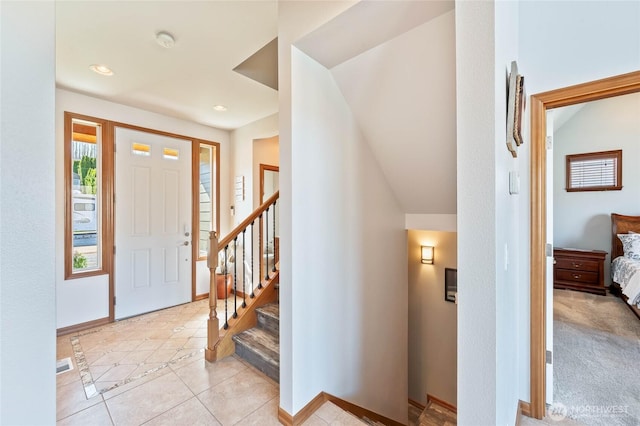 foyer entrance featuring stairs, light tile patterned floors, baseboards, visible vents, and recessed lighting