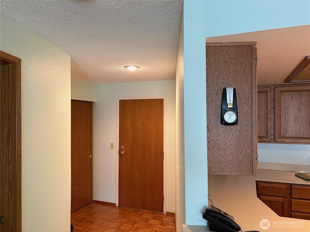 corridor with a textured ceiling