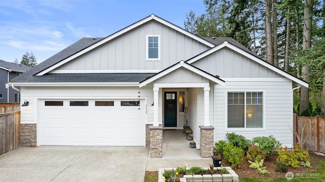 6620 165th Street Ct E, Puyallup, WA 98375 - view of front of property featuring a shingled roof, board and batten siding, fence, driveway, and stone siding