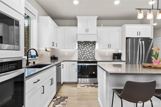 6620 165th Street Ct E, Puyallup, WA 98375 - kitchen with appliances with stainless steel finishes, a sink, white cabinetry, and recessed lighting