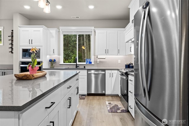 6620 165th Street Ct E, Puyallup, WA 98375 - kitchen featuring stainless steel appliances, a sink, white cabinetry, decorative backsplash, and recessed lighting