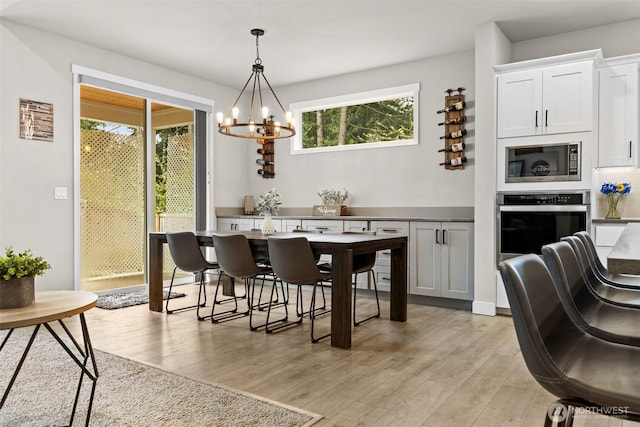 6620 165th Street Ct E, Puyallup, WA 98375 - dining area with light wood-type flooring and a chandelier