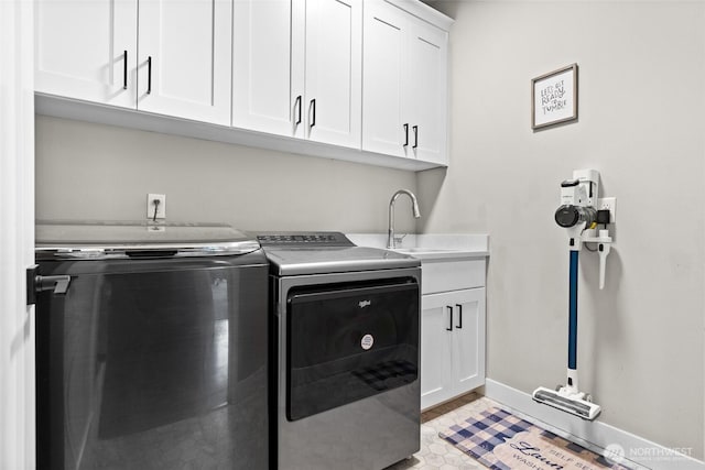 6620 165th Street Ct E, Puyallup, WA 98375 - laundry room featuring separate washer and dryer, cabinet space, and baseboards