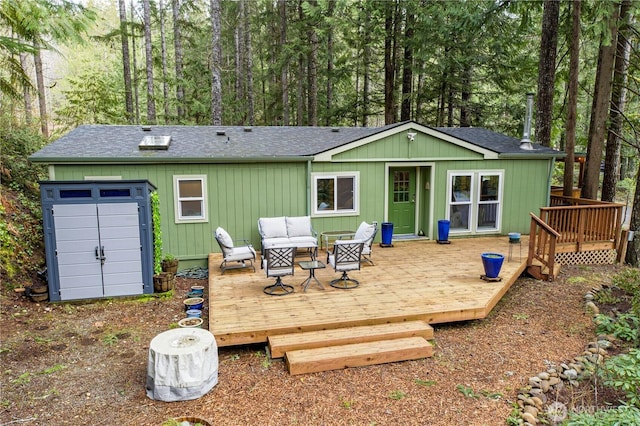 161 N Dow Mountain Rd, Hoodsport, WA 98548 - back of property with a shingled roof, an outdoor hangout area, an outbuilding, and a deck