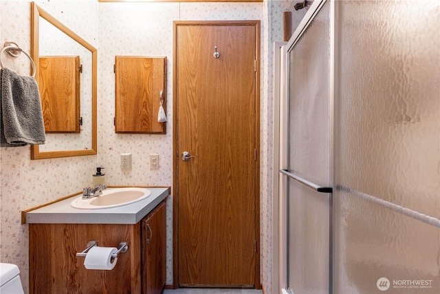 161 N Dow Mountain Rd, Hoodsport, WA 98548 - bathroom featuring wallpapered walls, a stall shower, toilet, and vanity
