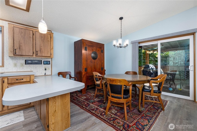 161 N Dow Mountain Rd, Hoodsport, WA 98548 - dining room with a textured ceiling, vaulted ceiling, light wood-type flooring, and a chandelier