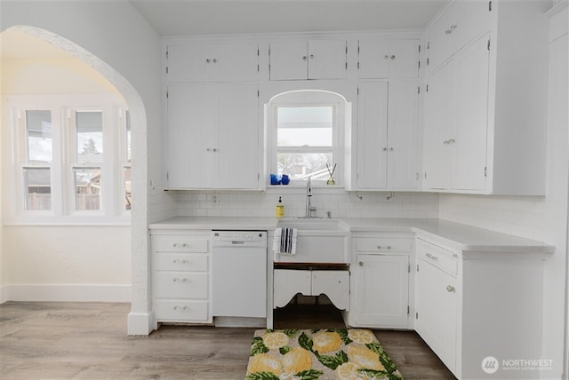 kitchen with white cabinetry, a sink, and dishwasher