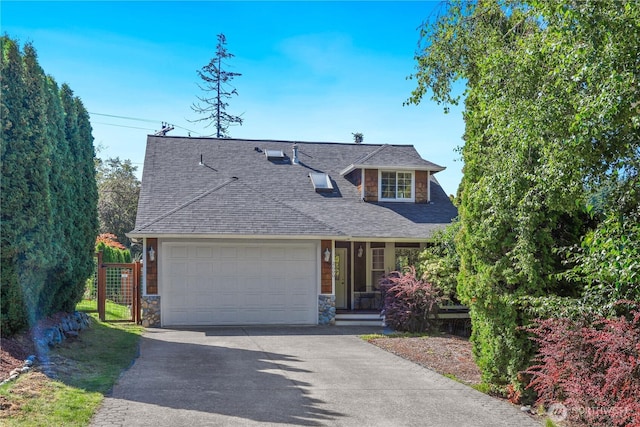 view of front of home with a shingled roof, a garage, stone siding, and aphalt driveway