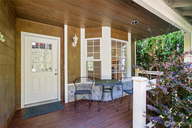 view of exterior entry featuring covered porch