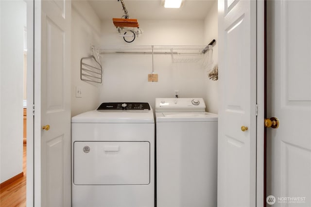 clothes washing area with washing machine and dryer and laundry area