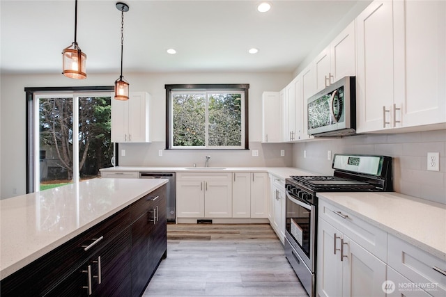 kitchen with white cabinetry, appliances with stainless steel finishes, and a sink
