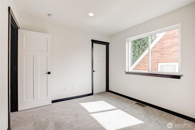 unfurnished bedroom featuring baseboards, visible vents, recessed lighting, and light colored carpet