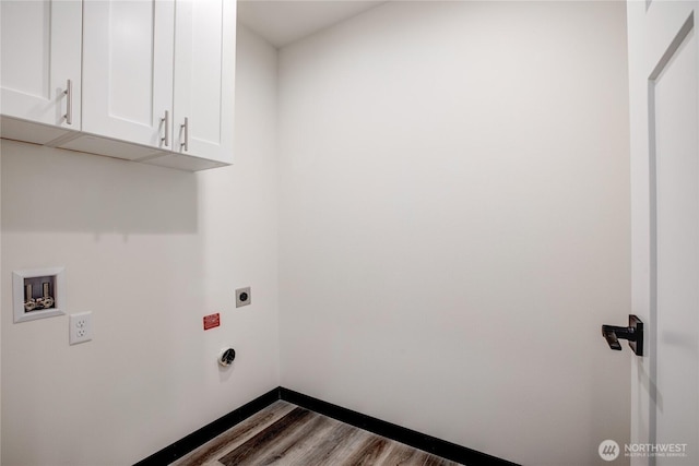 laundry area with hookup for an electric dryer, cabinet space, wood finished floors, baseboards, and hookup for a washing machine