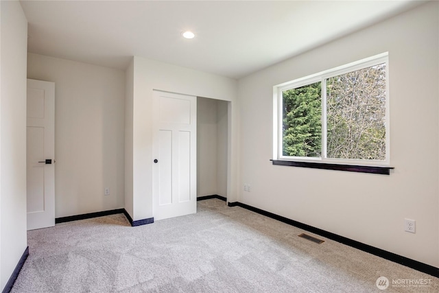 unfurnished bedroom featuring visible vents, baseboards, a closet, carpet, and recessed lighting