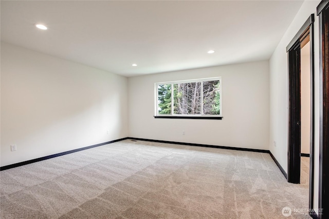 unfurnished bedroom featuring recessed lighting, baseboards, and light colored carpet