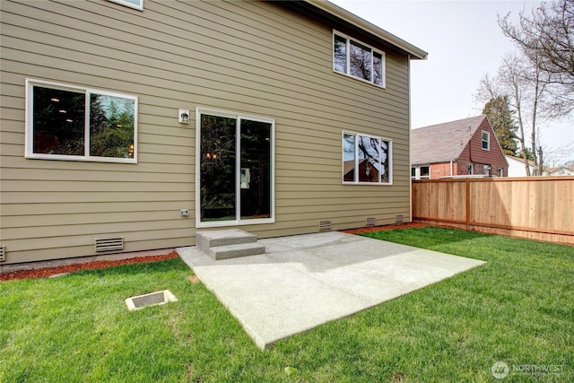 rear view of house featuring fence, a lawn, a patio area, and crawl space