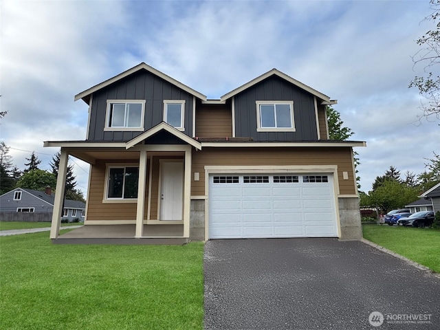 view of front facade with a garage, board and batten siding, and a front yard