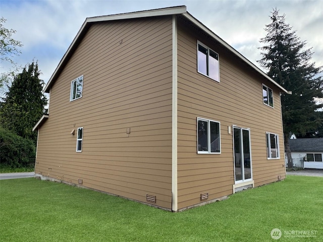 view of home's exterior featuring a lawn and crawl space