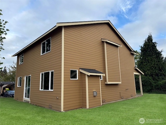 view of property exterior with a yard