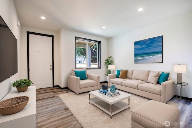 living room featuring recessed lighting, light wood-style flooring, and baseboards