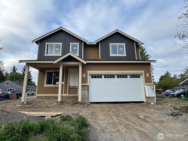 craftsman-style house featuring a garage, board and batten siding, and driveway