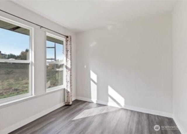 10601 55th Ave S, Seattle, WA 98178 - unfurnished room with baseboards and wood finished floors