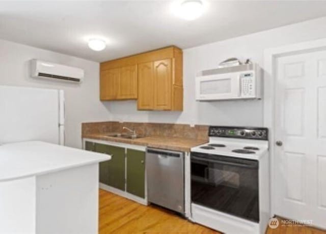 10601 55th Ave S, Seattle, WA 98178 - kitchen with light wood-style flooring, white appliances, a wall mounted air conditioner, and a sink