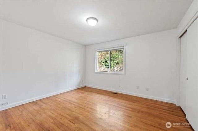 10601 55th Ave S, Seattle, WA 98178 - unfurnished bedroom featuring a closet, baseboards, and light wood finished floors
