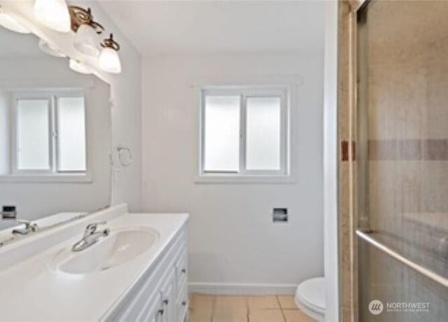 10601 55th Ave S, Seattle, WA 98178 - full bathroom with toilet, vanity, a shower with door, tile patterned flooring, and baseboards