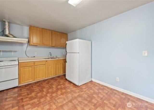10601 55th Ave S, Seattle, WA 98178 - kitchen with baseboards, light countertops, a sink, and white appliances
