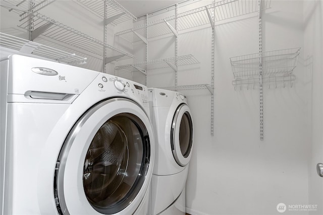 laundry area featuring washing machine and clothes dryer and laundry area