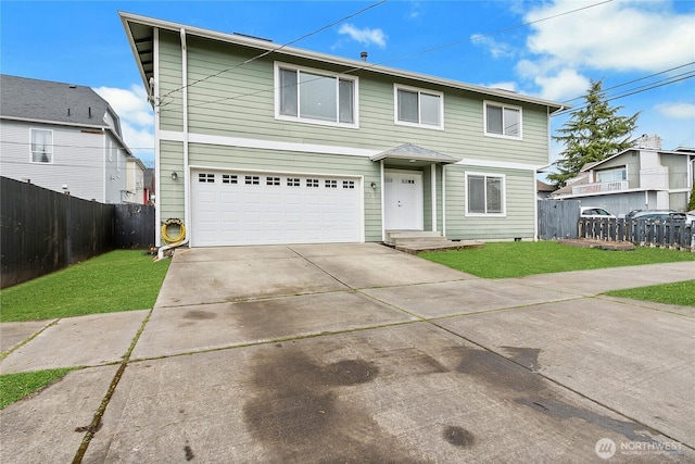 traditional-style house with an attached garage, fence, concrete driveway, and a front yard