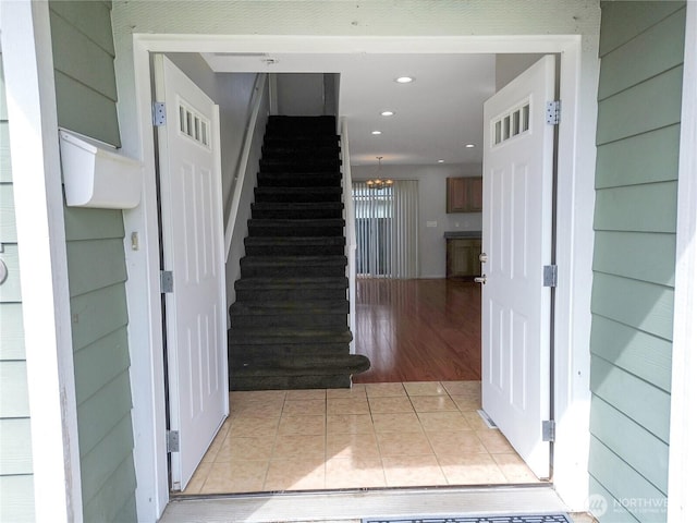 staircase with tile patterned flooring and recessed lighting