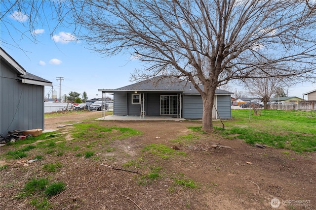 back of house featuring a patio area, a yard, and fence