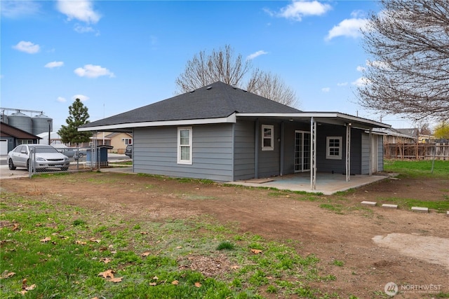 rear view of house featuring a patio area and fence