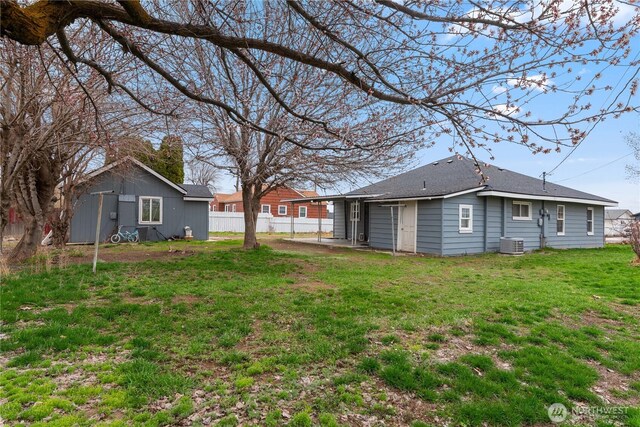 view of yard featuring central air condition unit, a patio area, and fence