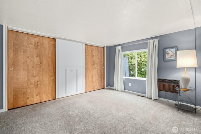 unfurnished bedroom with visible vents, baseboards, and carpet