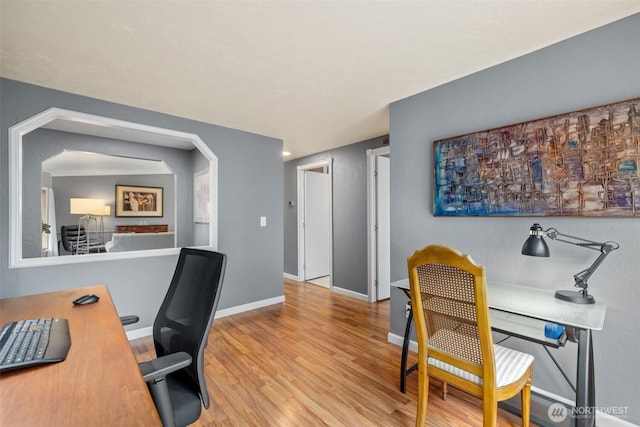office featuring baseboards and wood finished floors