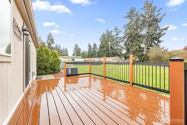 wooden deck featuring a lawn