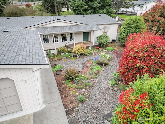 exterior space featuring roof with shingles