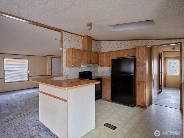 1850 Heartwood Dr, Woodland, WA 98674 - kitchen with wallpapered walls, black appliances, under cabinet range hood, and light floors