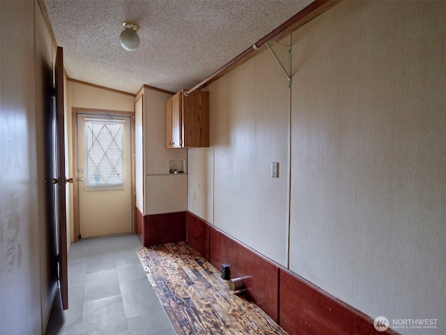 1850 Heartwood Dr, Woodland, WA 98674 - interior space with crown molding, wood walls, a textured ceiling, a wainscoted wall, and light floors